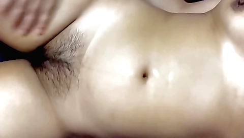 Long haired amateur with hairy pussy is getting massaged