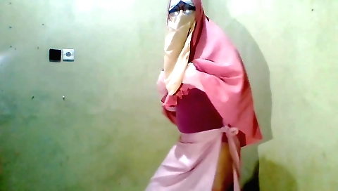 Hijab girl with a sexy face is playing with a dildo