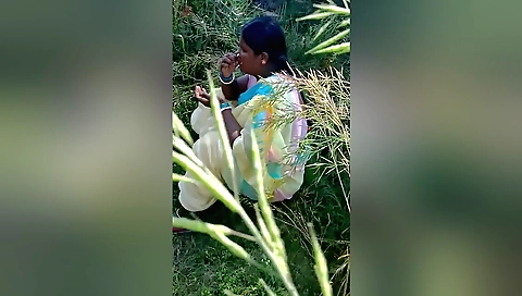 Indian brunette playing with hair and clothes outdoors