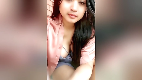 A sexy indian girl is driving in a small black car
