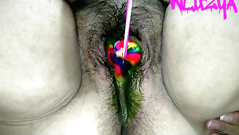Indian girl gives a candy lollipop to her boyfriend
